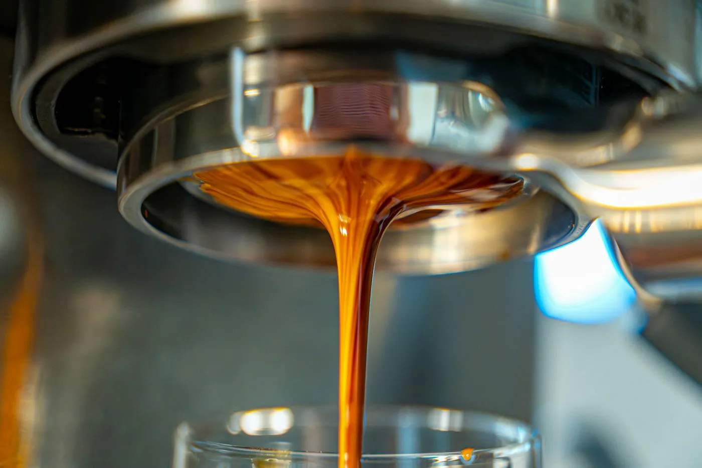 Fresh espresso pouring into a glass, showing the caffeine base of 7 Brew drinks