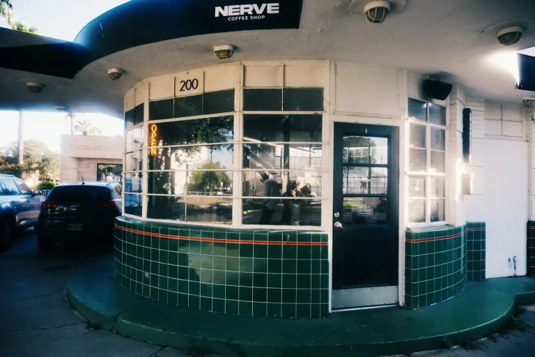 Small drive-thru coffee stand building with a service window