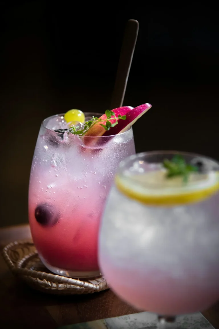 Pink sparkling soda over ice in a clear glass, similar to a 7 Brew Fizz soda