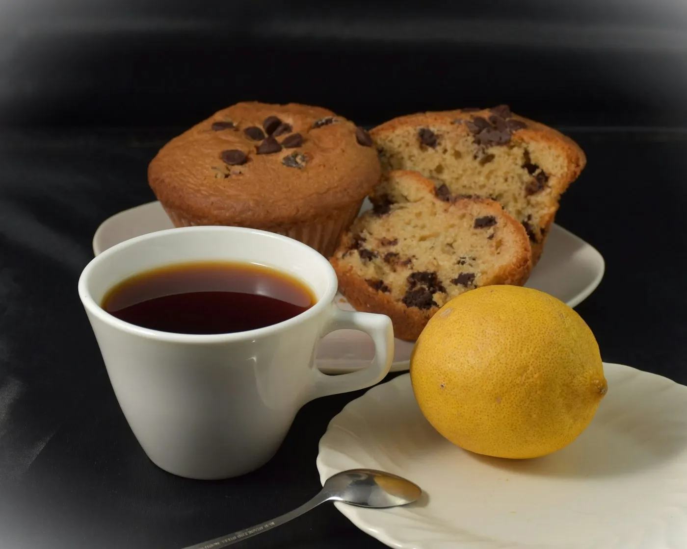 Chocolate chip muffins served next to a cup of coffee